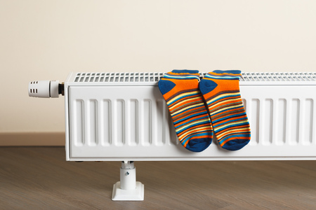 striped socks are being dry on the radiatorの写真素材