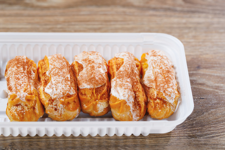 eclairs pastry in a plastic box, close-up viewの写真素材
