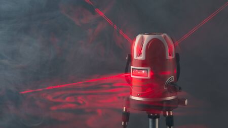 laser level tool red light beams in smoke