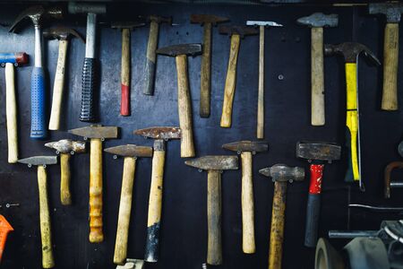 wall with rusty hammers in old garage