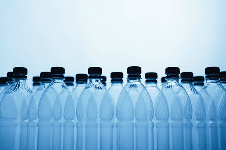 empty plastic bottle silhouettes on blue backgroundの写真素材