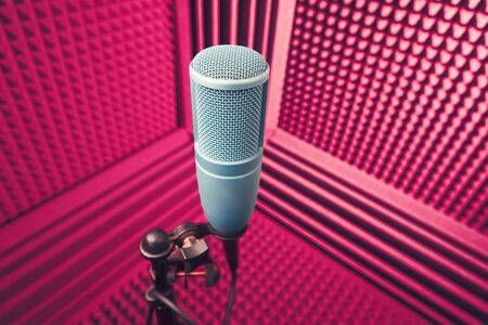 professional microphone in sound recording studio, purple acoustic foam backgroundの写真素材