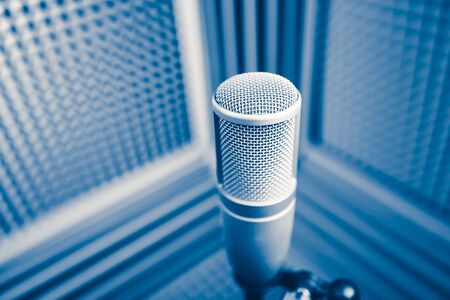 professional microphone in sound recording studio, blue acoustic foam backgroundの写真素材