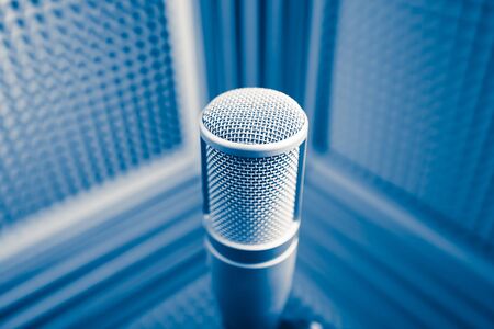 professional microphone in sound recording studio, blue acoustic foam backgroundの写真素材