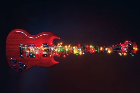 electric guitar with festive Christmas lights