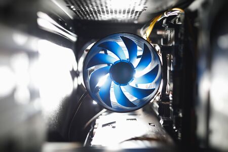 blue cpu cooler inside PC case, shiny light backgroundの写真素材