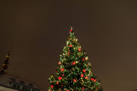 Christmas tree with decorations and lights, european Christmas market at nightの写真素材