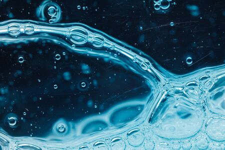 abstract liquid soap bubbles blue background