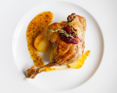 roasted duck leg with potato and mustard sauce, top viewの写真素材