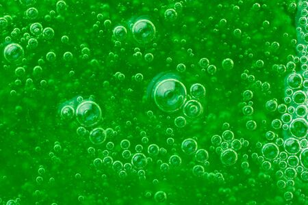 abstract liquid soap bubbles green background