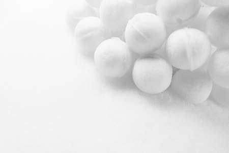 many snowballs on white snow background with copy-spaceの写真素材