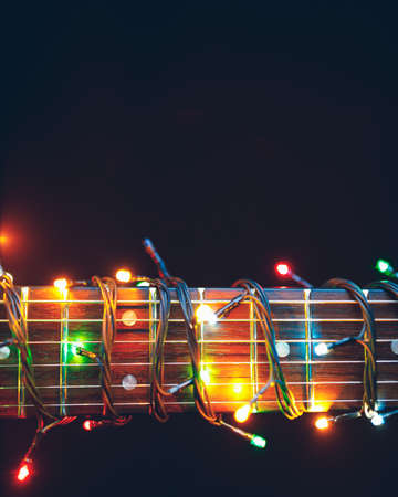 guitar finger-board with multicolor lights, festive background