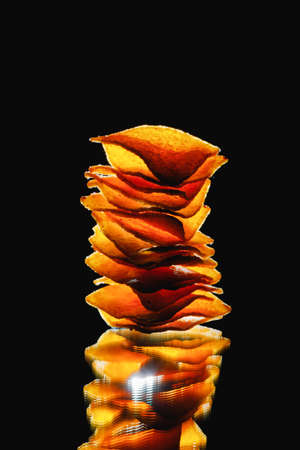 mexican nachos tortilla chips stack, black backgroundの写真素材