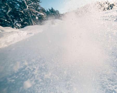 snow splash in the air, blue snow background