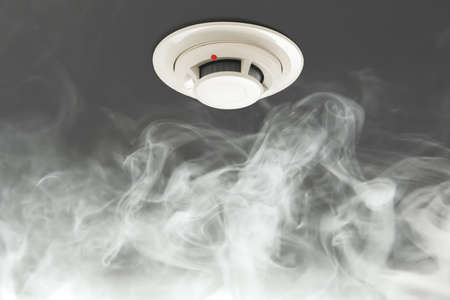 smoke detector on ceiling, fire alarm in actionの写真素材
