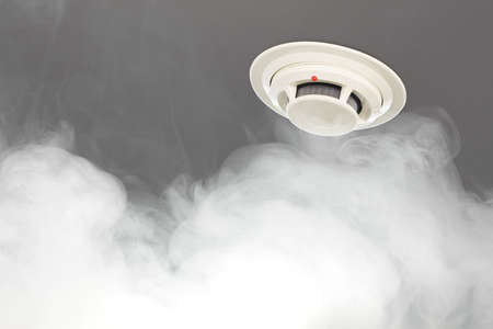 smoke detector on ceiling, fire alarm in actionの写真素材