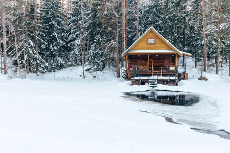 russian sauna banya house in winter forest nearby the lake with ice-holeの写真素材