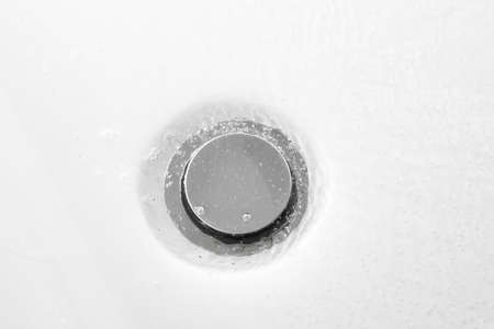 bathtub drain, close-up view, white backgroundの写真素材