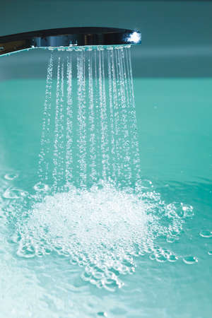shower filling a bathtub with water stream