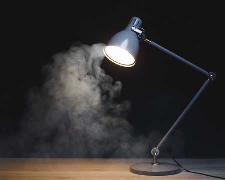abstract desk lamp with smoke, dark backgroundの写真素材
