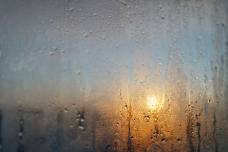 frost on the window at sunset