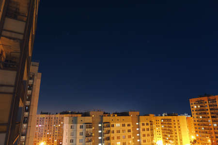 apartment buildings courtyard with view to the night sky and stars on blue background with copy-spaceの写真素材