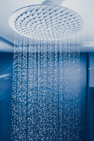 water drops falling from large rain shower headの写真素材