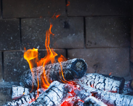 burning fire logs in fireplaceの写真素材