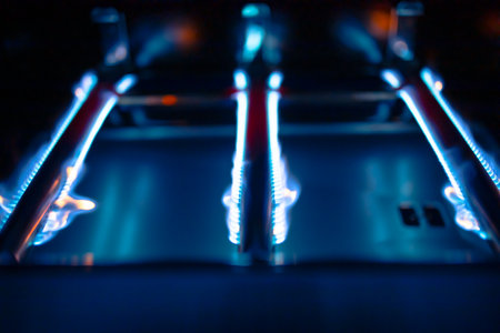 blue fire of a gas grill tube burners, closeup viewの写真素材