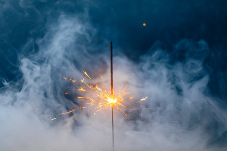 fire sparkler in dense smoke, abstract Christmas firework backgroundの写真素材