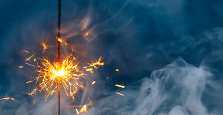 fire sparkler in dense smoke, abstract Christmas firework backgroundの写真素材
