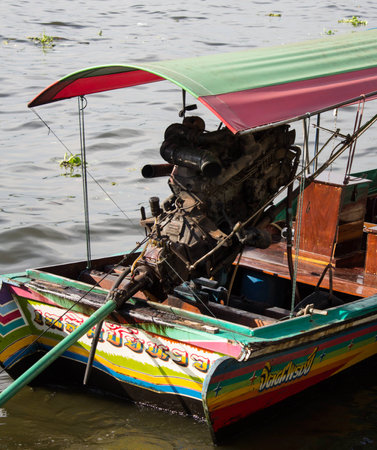 Big outboard diesel engine on a small tourist transportation boat in Bangkok, Thailand, Asia.の写真素材