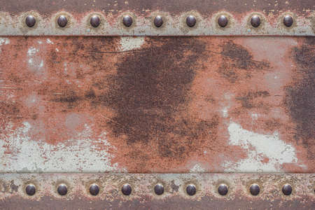 old painted iron plate with shiny rivetsの写真素材