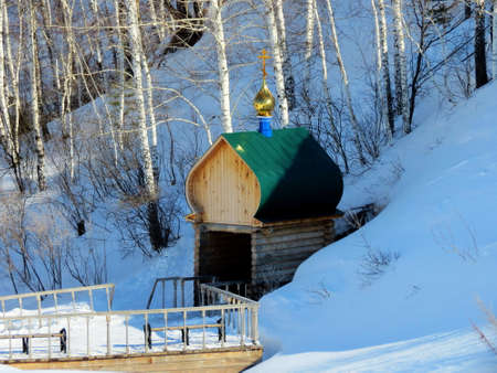 Rustic church in winter and summer decorates rural landscapeの写真素材