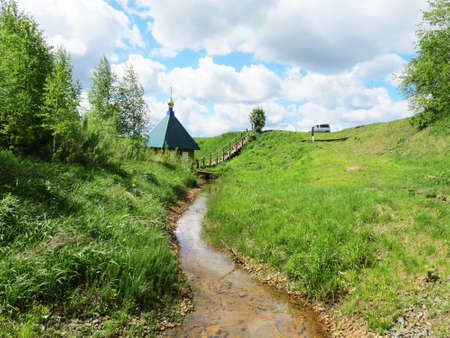 Rustic church in winter and summer decorates rural landscapeの写真素材