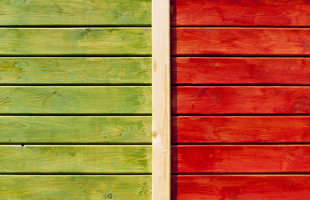 wooden wall painted in green and bright orange close-up backgroundの写真素材