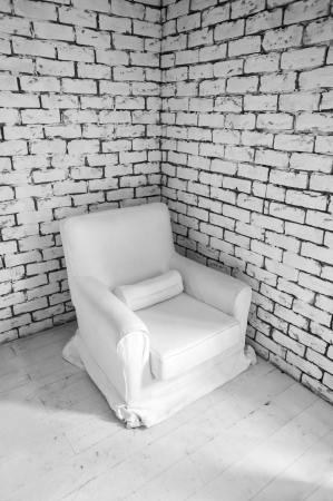 simple white wall interior with armchair in cornerの写真素材