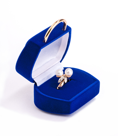 gold ring with pearls in blue velvet gift box on white background の写真素材