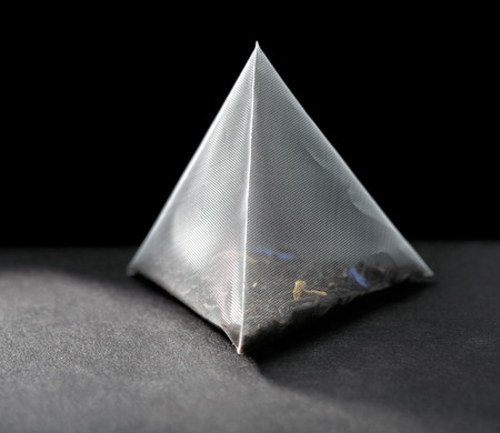 pyramid tea bag on black backgroundの写真素材