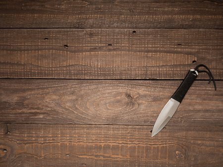 Knife for throwing on a wooden table ready for heavy work