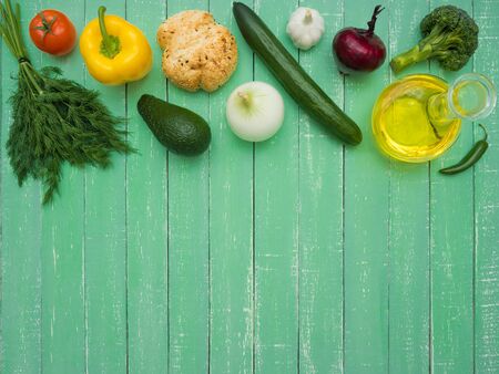 Fresh, healthy vegetables, decanter with sunflower oil and bread on a wooden tableの写真素材