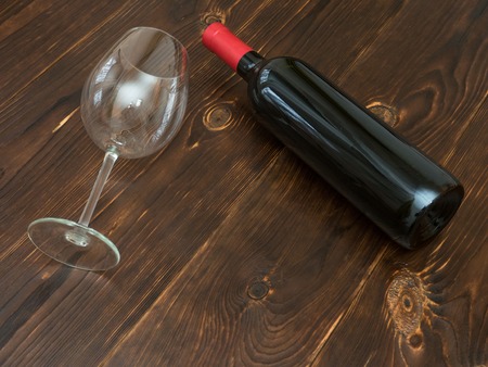 Bottle of red wine and a glass on the tableの写真素材