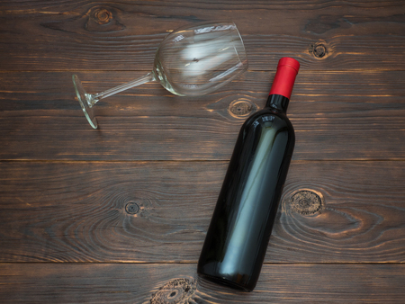 Bottle of red wine and a glass on the tableの写真素材