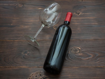 Bottle of red wine and a glass on the tableの写真素材