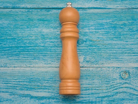 Wooden universal mill for pepper and salt lies on a tableの写真素材