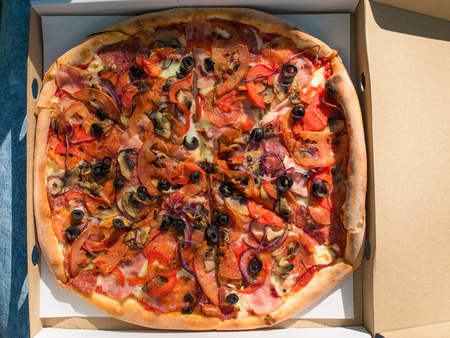 Large, juicy, appetizing pizza in an open boxの写真素材