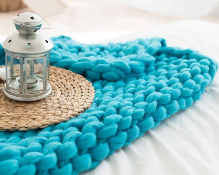 Vintage candlestick in a turquoise large knit plaidの写真素材