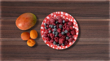 Berries in a plate on the table, mozilla, avocado, peaches, irgaの写真素材