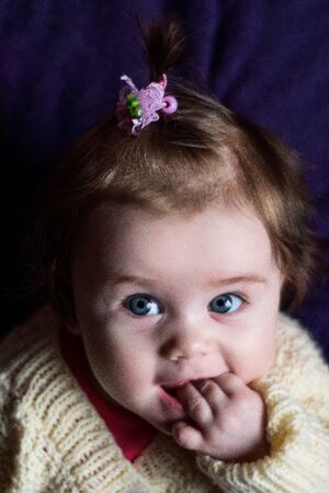 The baby fascinates us with her look and smileの写真素材