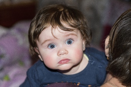 The baby fascinates us with her look and smileの写真素材